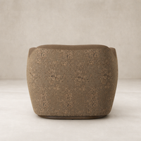 Poppy Swivel Chair in Fallingbrook Cafe with textured floral upholstery and rounded shape.