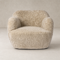 Beige shearling Poppy Swivel Chair with plush, rounded design and cozy texture.