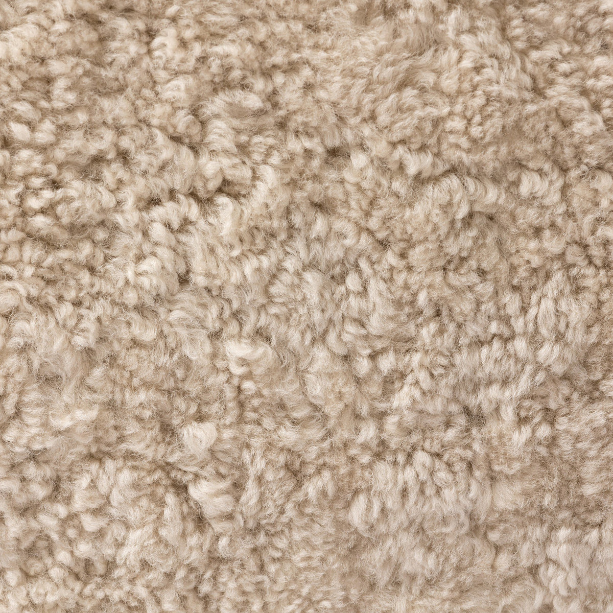 Close-up of the soft, textured beige shearling fabric of the Poppy Swivel Chair.