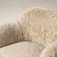 Close-up of the Poppy Swivel Chair in beige shearling showcasing its plush texture and cozy design.