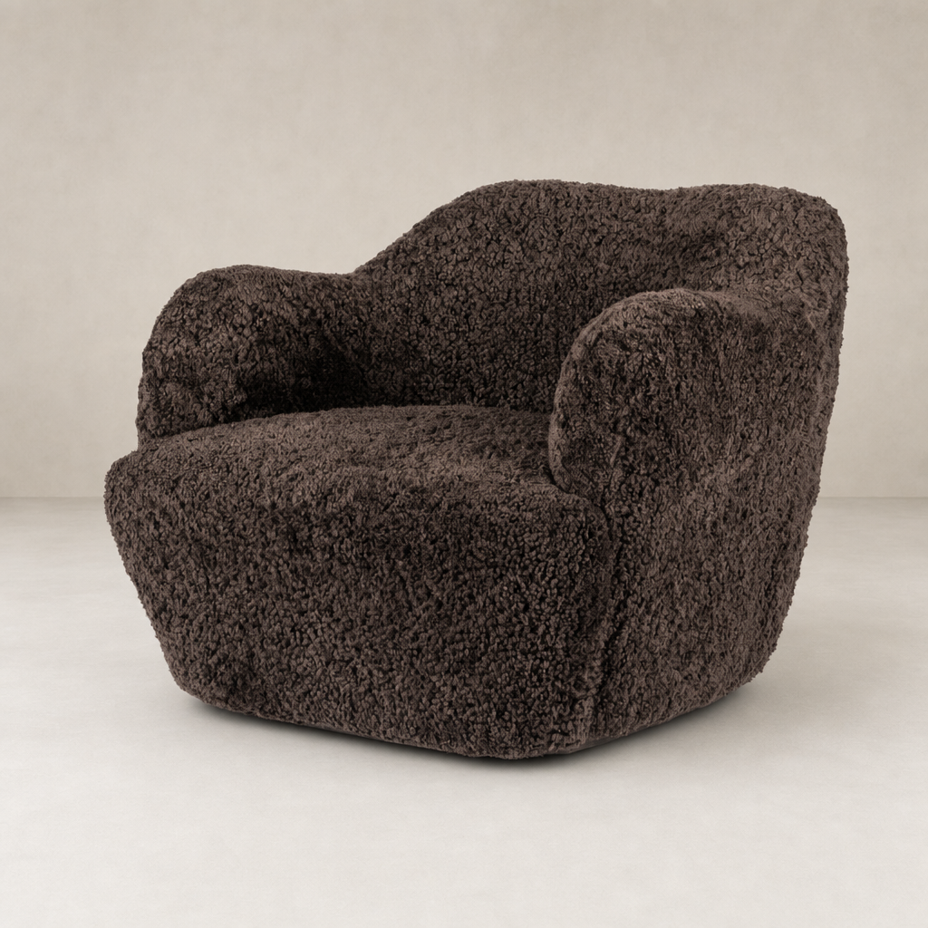Cocoa shearling Poppy Swivel Chair with soft, textured upholstery and rounded arms.