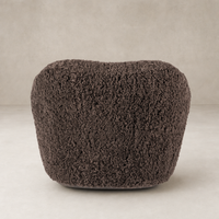 Cocoa shearling Poppy Swivel Chair with a plush, rounded design for comfort.
