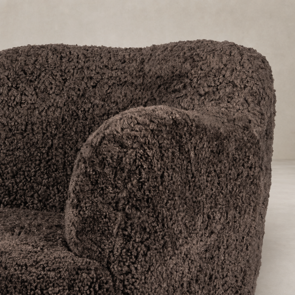 Poppy Swivel Chair in cocoa shearling with plush, textured upholstery and rounded arms.