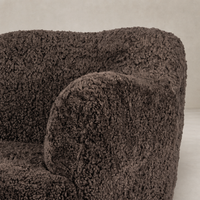 Poppy Swivel Chair in cocoa shearling with plush, textured upholstery and rounded arms.