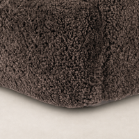 Cocoa shearling texture detail of the Poppy Swivel Chair's plush upholstery.