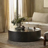Milo Coffee Table in bluestone, featuring a sleek round design in a cozy living room setting.