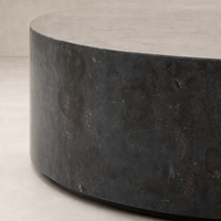 Milo Coffee Table in Bluestone with a sleek, round design and textured finish.