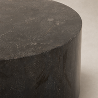 Keller End Table featuring a smooth circular top and sleek dark surface finish.