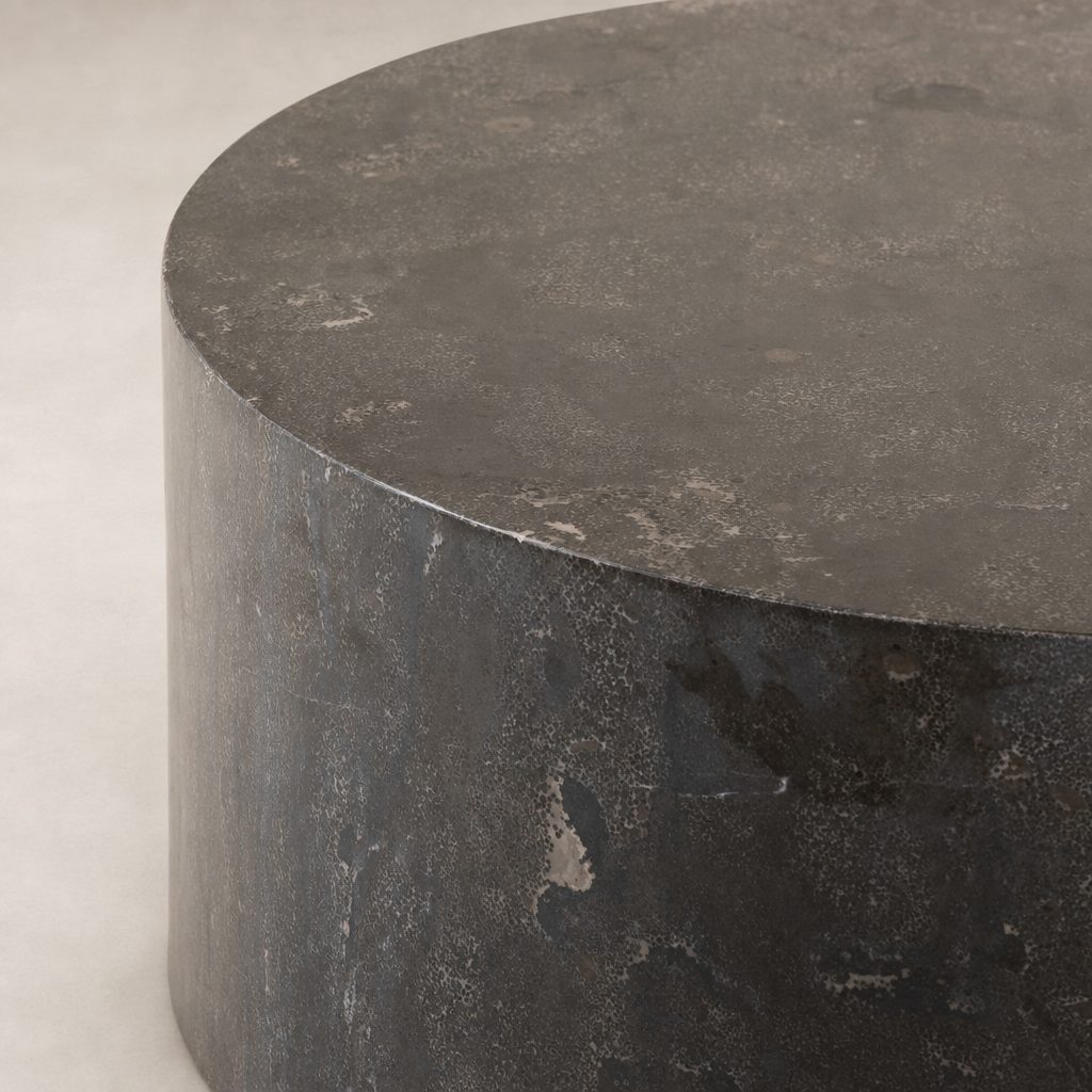 Keller End Table featuring a sleek, round design with a textured dark finish.