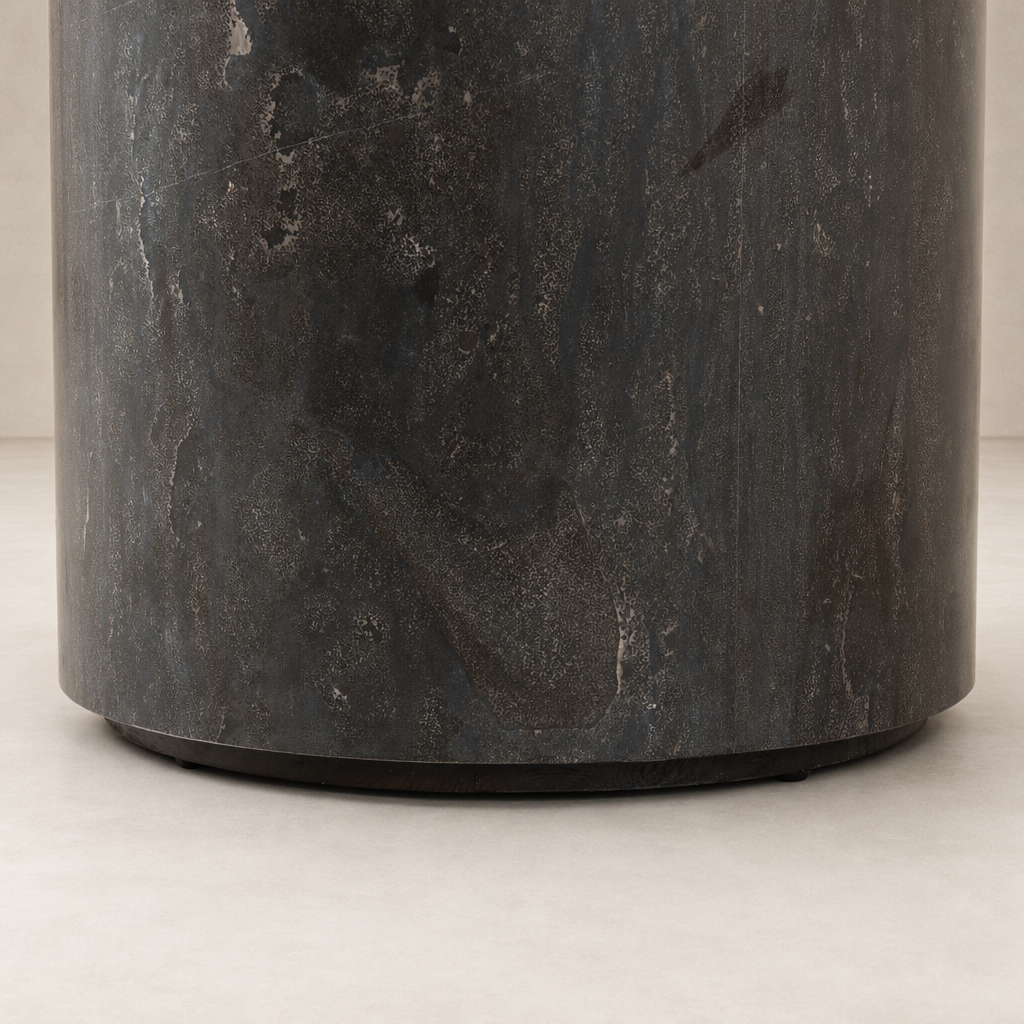 Keller End Table featuring a sleek, dark stone texture and round base.