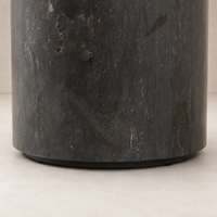Keller End Table featuring a sleek, dark stone texture and round base.