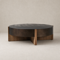 Distressed Iron Ashby Large Coffee Table with a round top and contrasting wooden legs.