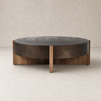 Round Ashby Large Coffee Table in distressed iron with wooden legs and rustic finish.