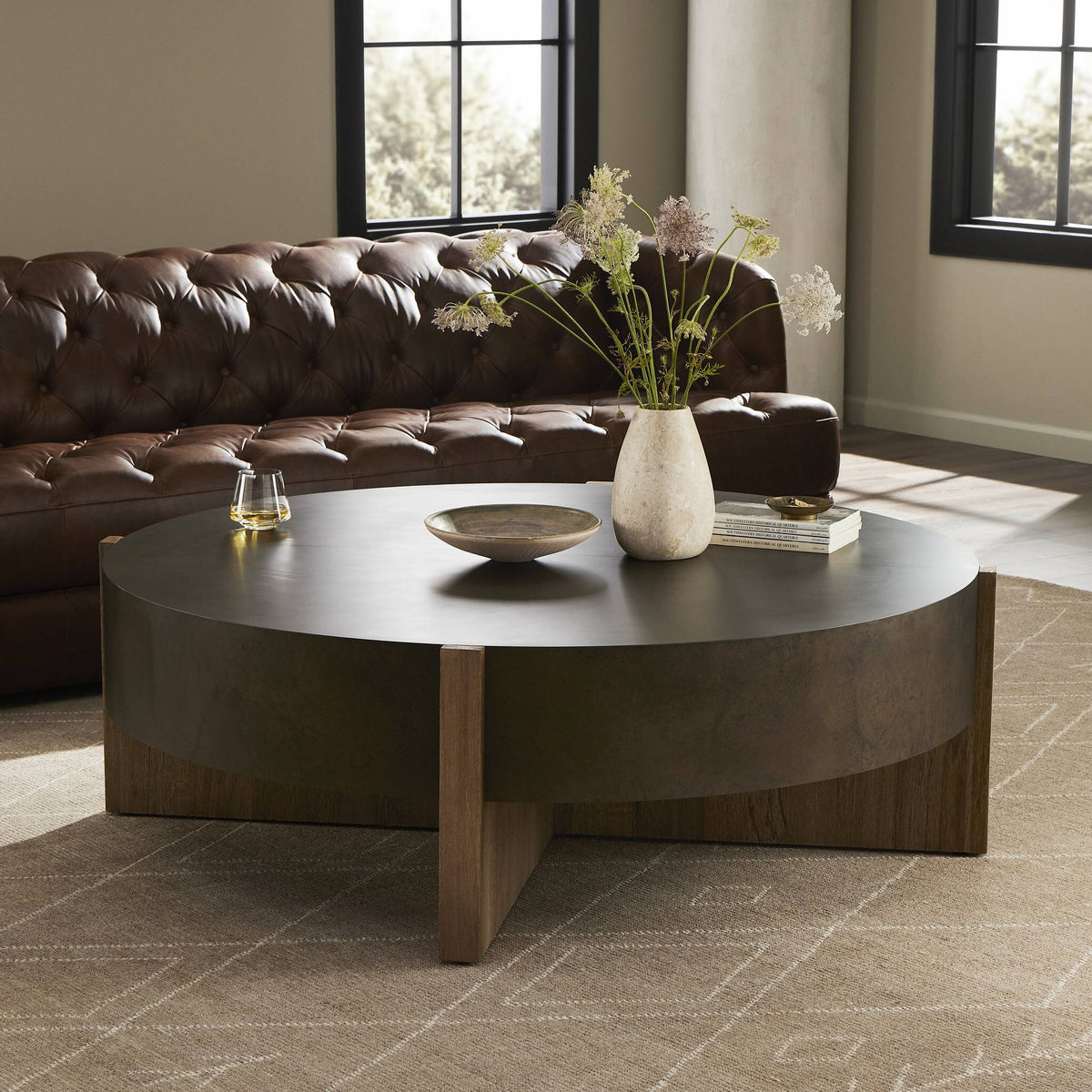 Ashby Large Coffee Table in distressed iron with round shape and wood accents.