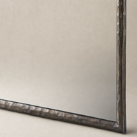 Bexley Wall Mirror with a textured Smoked Nickel frame in a studio setting.