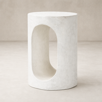 Atlas End Table features a unique oval cutout design and a smooth, minimalist white finish.
