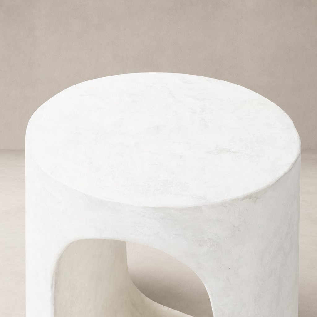 Atlas End Table in a smooth white finish features a modern round shape with unique cutouts.