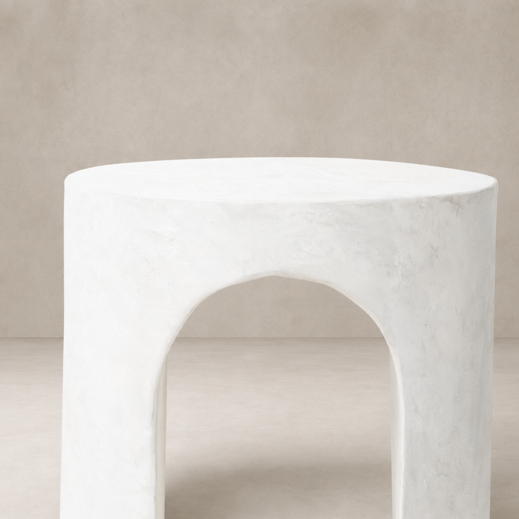 Atlas End Table in white with a smooth, rounded design and arched cutouts.
