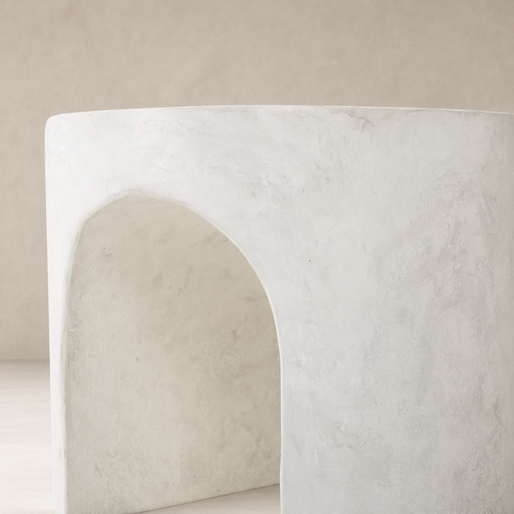 Atlas End Table with a smooth, curved design and textured white finish.