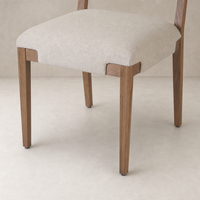 Nori Dining Chair in Antwerp Natural featuring a soft cushioned seat and sturdy wooden legs.