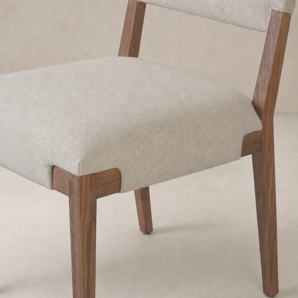 Nori Dining Chair in Antwerp Natural features a sleek design with soft cushions and wooden legs.