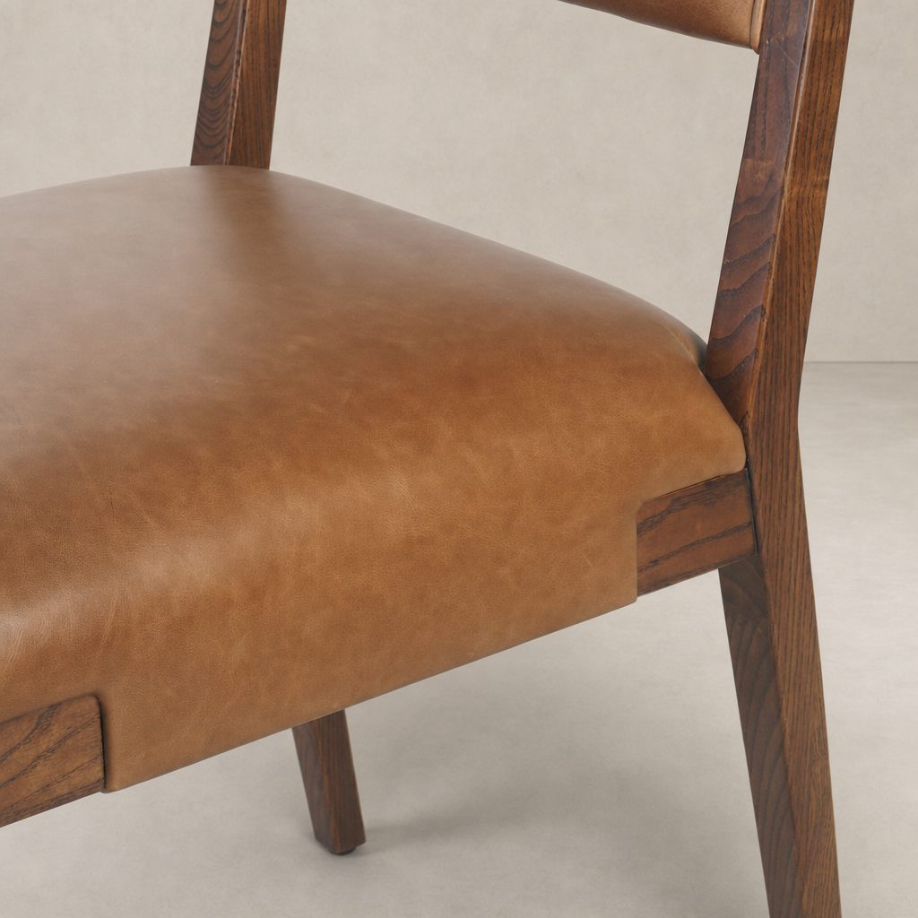 Nori Dining Chair featuring a Sonoma Chestnut finish with sleek contours and soft leather seat.