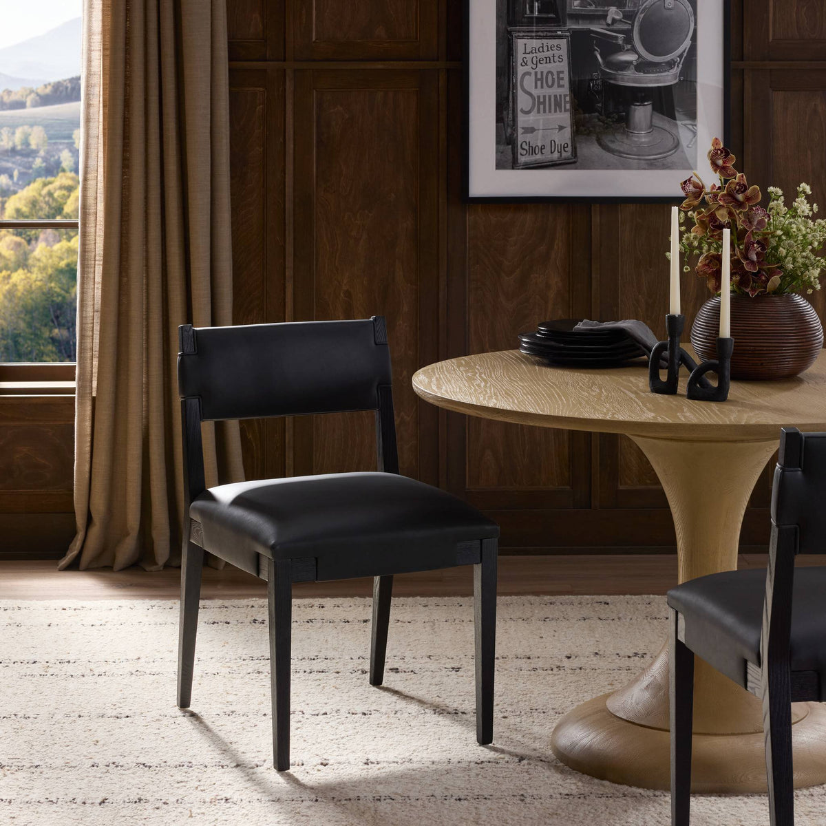 Nori Dining Chair in Brickhouse Black featuring a sleek design, set against a stylish dining area.