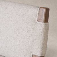 Bex Bar + Counter Stool in Antwerp Natural showcasing textured upholstery and wooden detail.