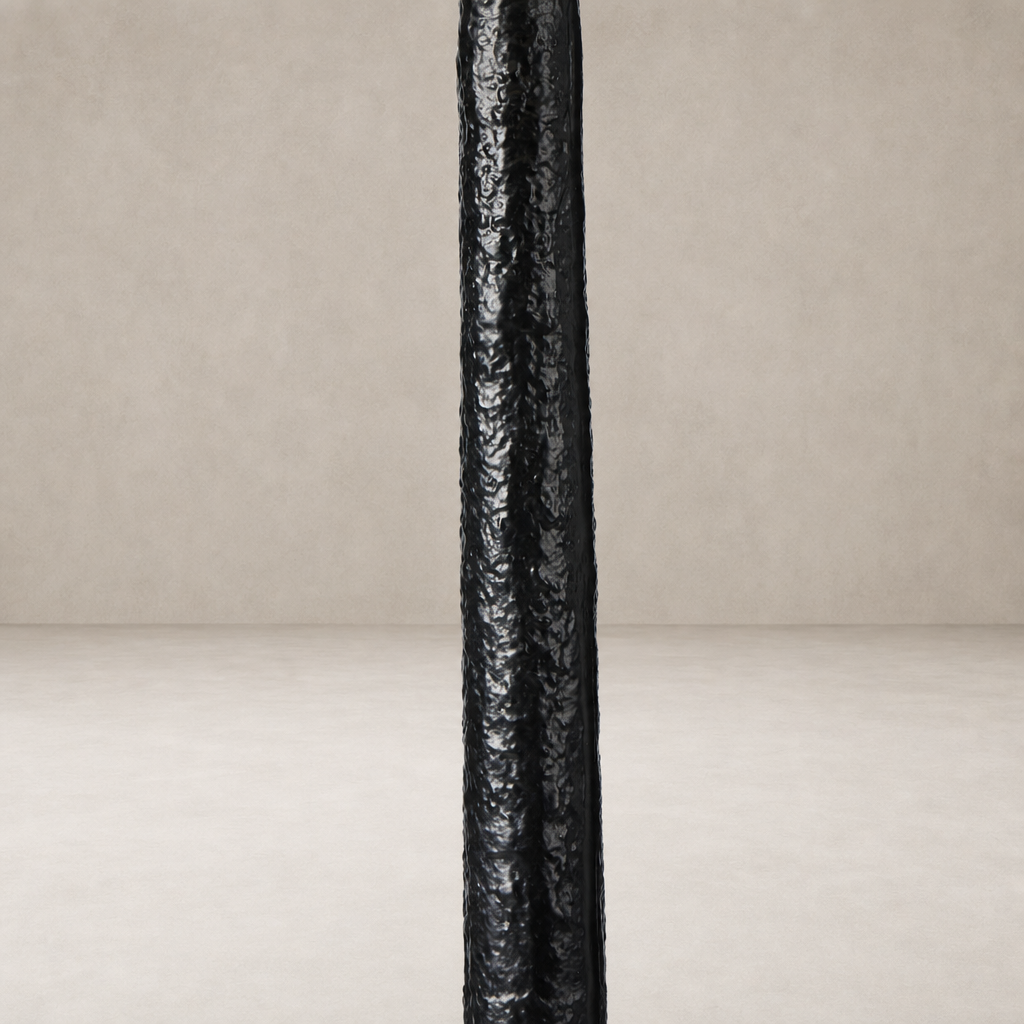 Matte black cast aluminum floor lamp with a textured surface design.