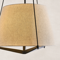 Matte black pendant lamp with a textured, tapered shade emitting warm light.