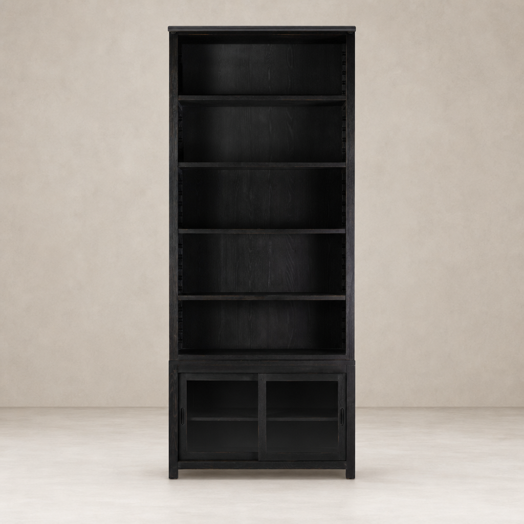 Zanzibar Bookcase in worn black features open shelves and a sleek design.