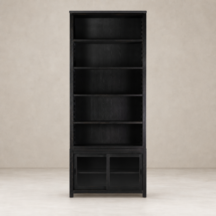 Zanzibar Bookcase in worn black features open shelves and a sleek design.