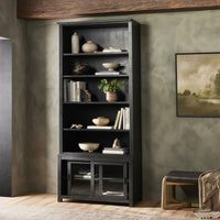Zanzibar Bookcase in worn black showcasing open shelves and glass-fronted storage.