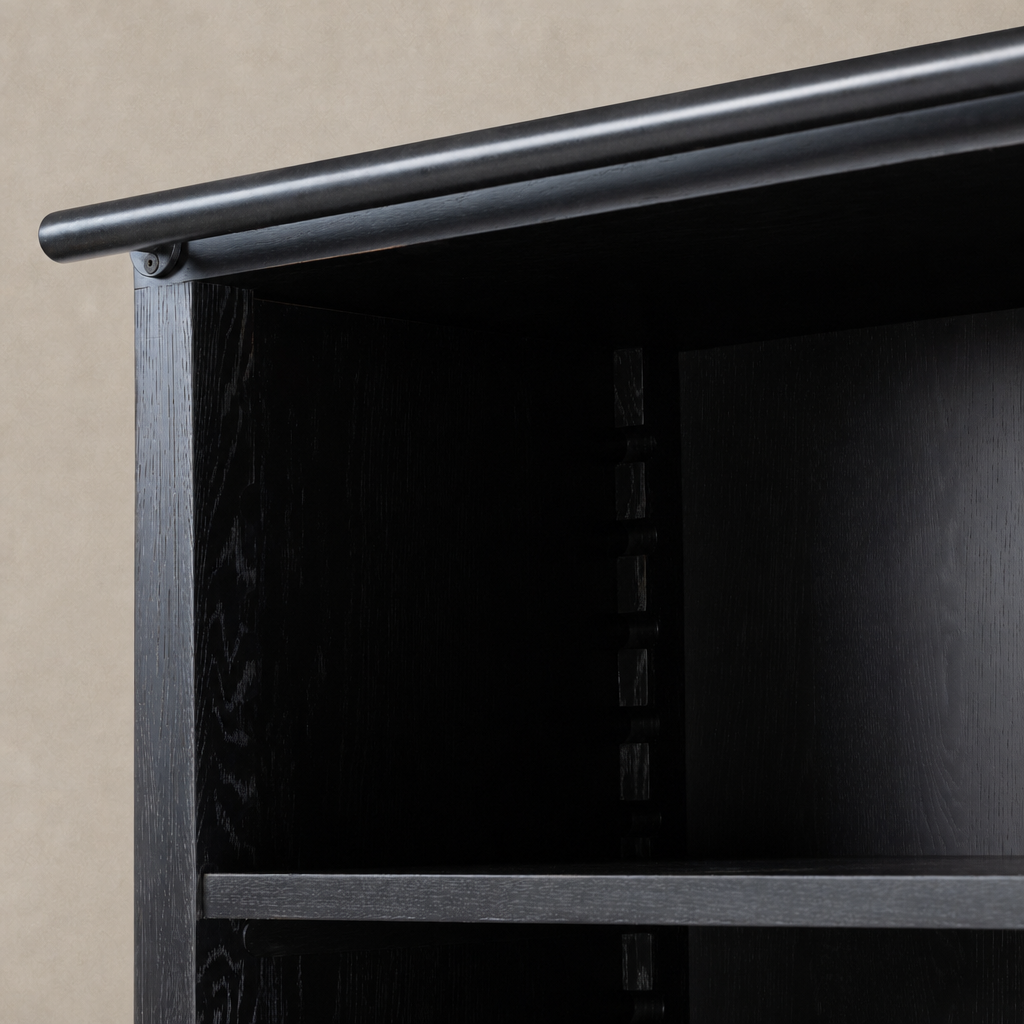 Close-up of the Zanzibar Bookcase's worn black finish and sturdy shelf support.
