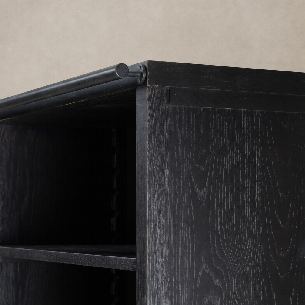 Close-up of Zanzibar Bookcase featuring a worn black finish and sturdy construction.