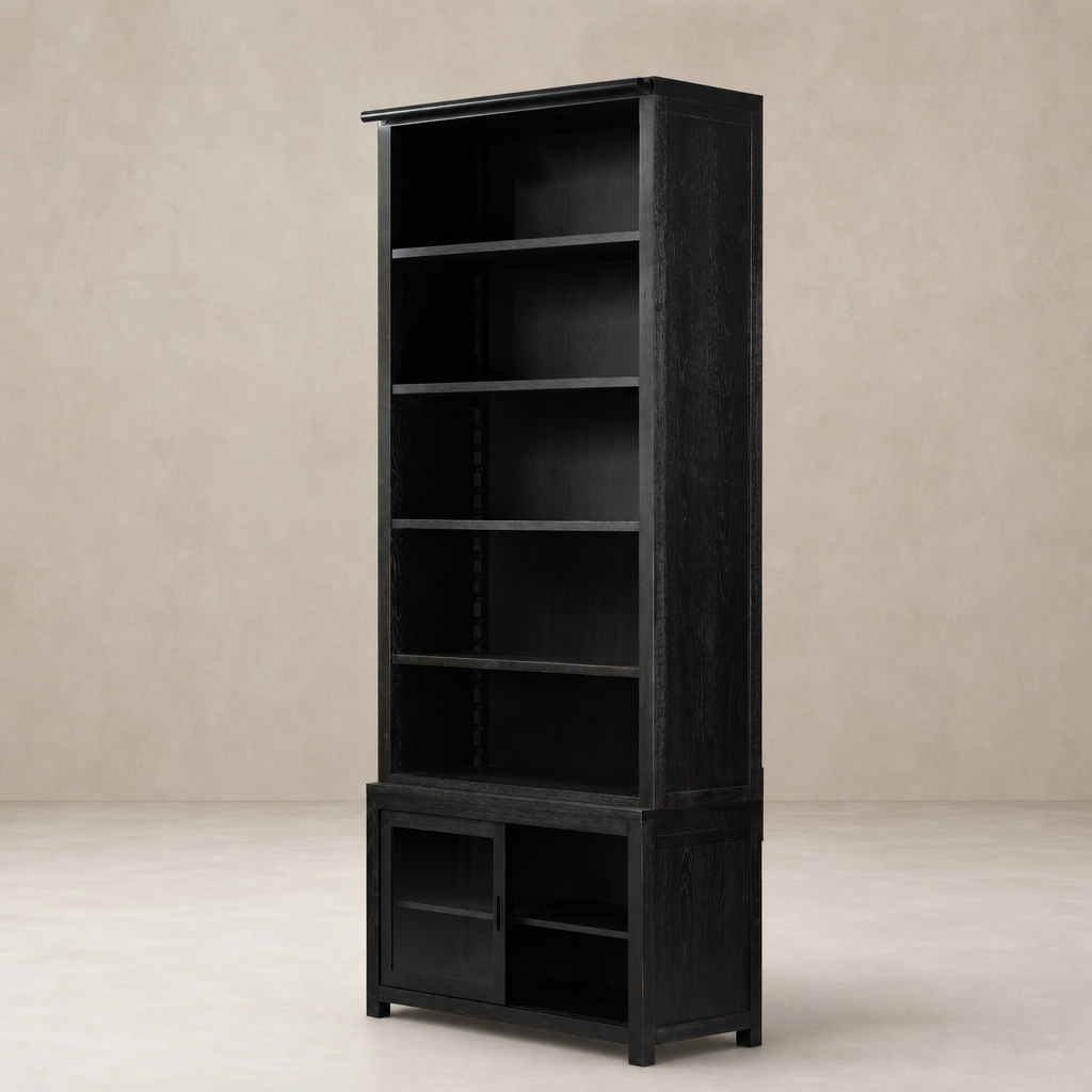 Zanzibar Bookcase in worn black featuring open shelves and closed storage cabinet.