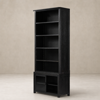 Zanzibar Bookcase in worn black featuring open shelves and closed storage cabinet.