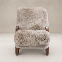 Livia Chair in taupe Mongolian fur with wooden armrests and plush texture.