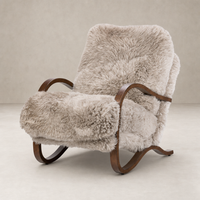 Livia Chair in taupe Mongolian fur with elegant curved wooden legs.
