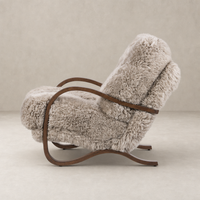 Livia Chair in taupe Mongolian fur with curved wooden frame, offering cozy comfort.