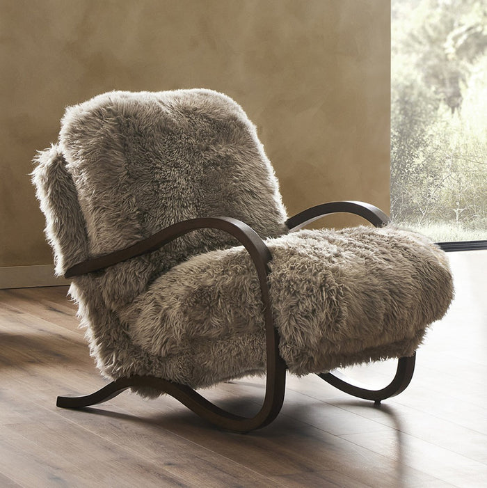 Livia Chair in taupe Mongolian fur with a sleek wooden frame.