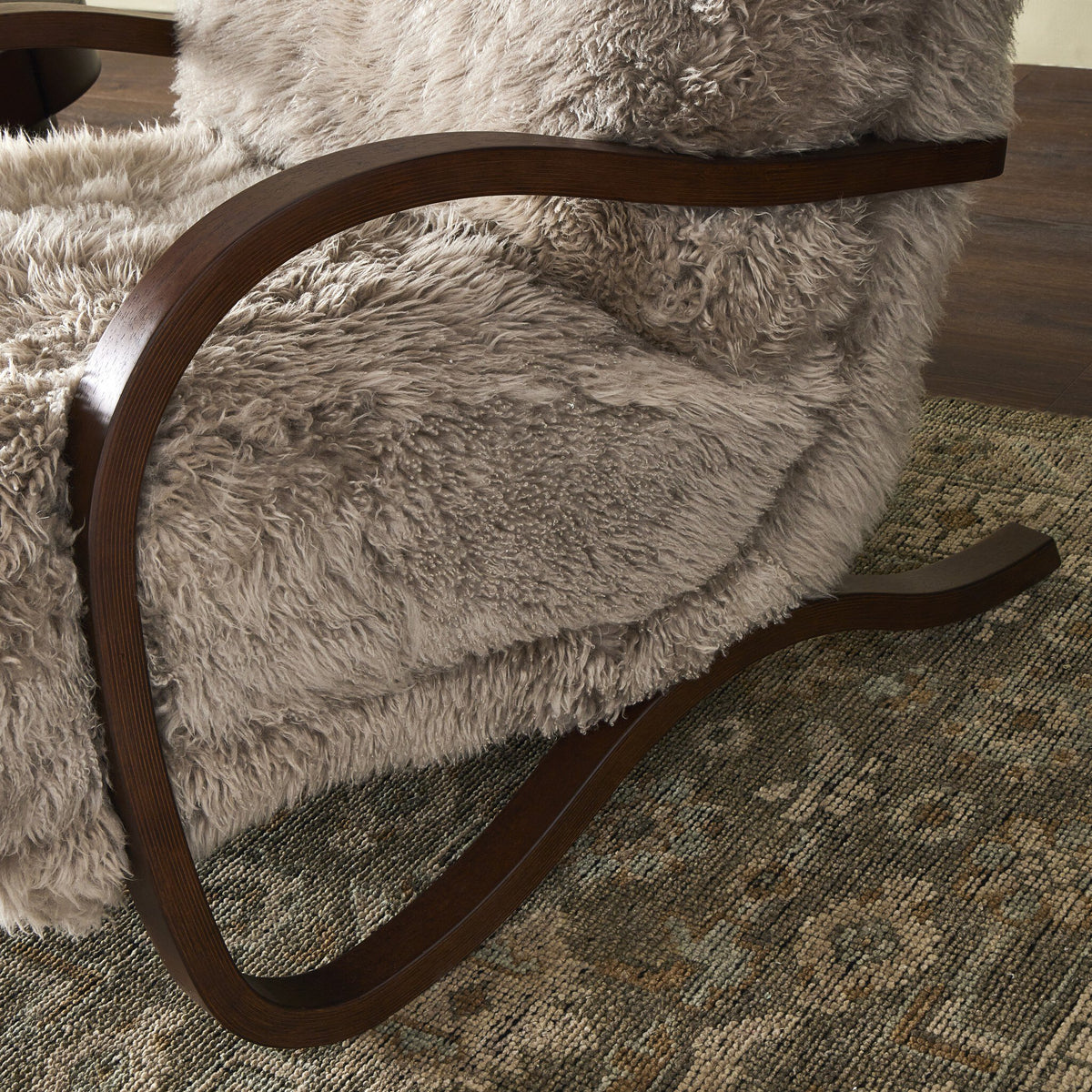 Livia Chair with taupe Mongolian fur upholstery and elegant curved wooden arms.