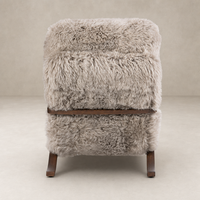 Livia Chair in taupe Mongolian fur with plush texture and sturdy wooden legs.