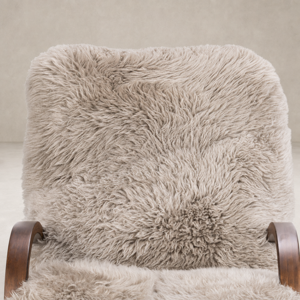 Livia Chair in taupe Mongolian fur with soft, textured upholstery and wooden armrests.