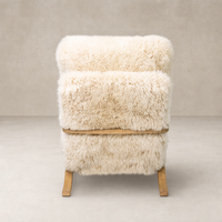Livia Chair in champagne Mongolian fur with a soft, cozy texture and wooden legs.
