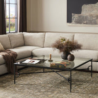 Close-up of the Selene Coffee Table featuring a sleek glass top and elegant black metal frame.