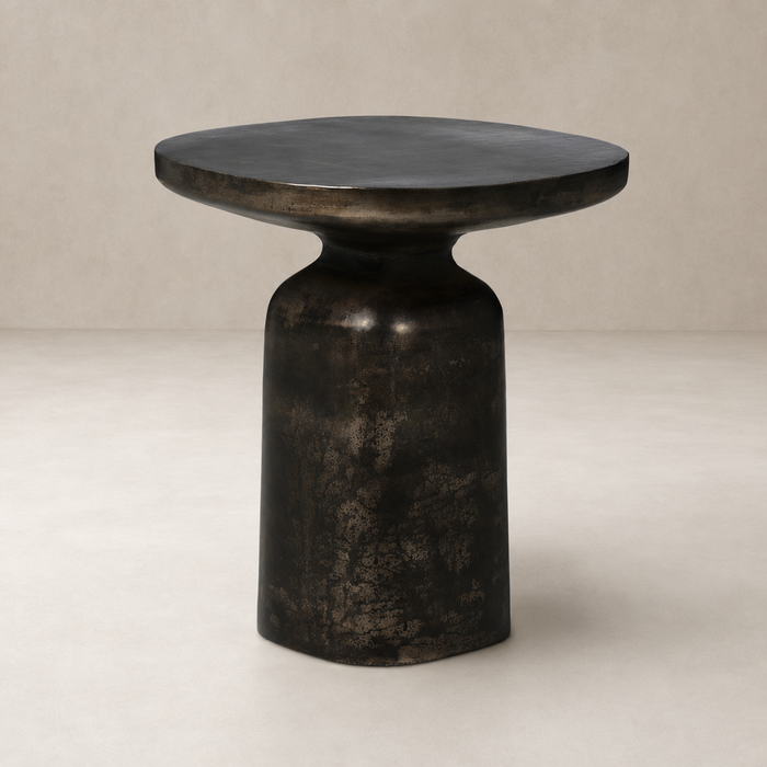Stylish Odette End Table with a rounded top and sculptural black finish.
