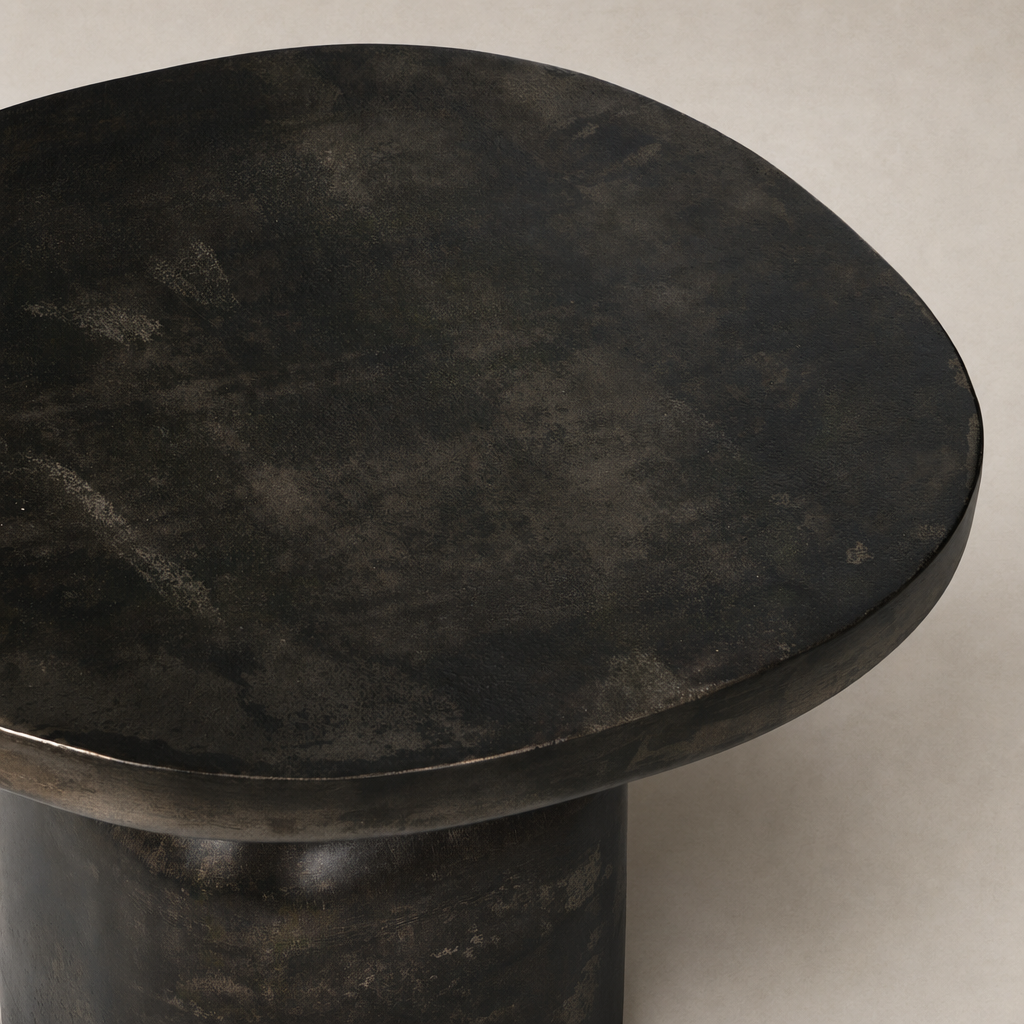 Odette End Table with a smooth, round dark surface and solid cylindrical base.