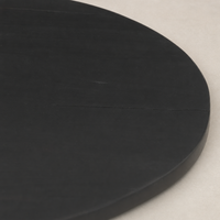 Close-up of the Neri End Table’s sleek black surface highlighting its smooth, contemporary finish.