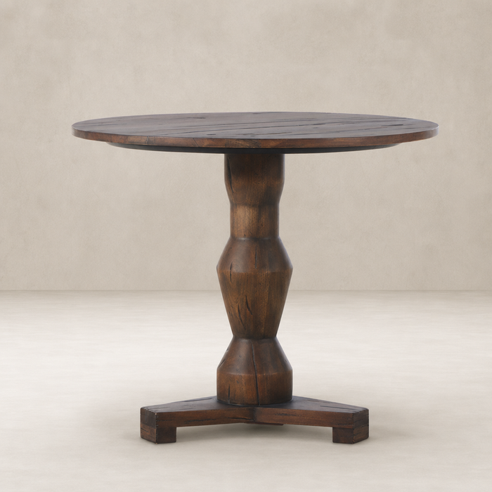 Riva Large End Table features a round top and sculptural wooden base with a natural finish.